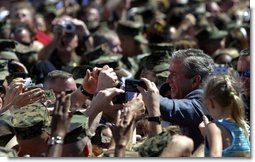 Президент Джордж У. Буш здоровается с морскими пехотинцами и их  родными после выступления в Кемп-Лежен в Джексонвилле, штат Северная Каролина, в четверг 3 апреля 2003 год. Фотограф Белого Дома Пол Морзе