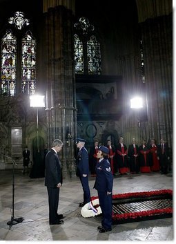 President George W. Bush bows his head in silence as a wreath is laid at the Tomb of the Unknown Warrior at Westminster Abbey in London Thursday, Nov. 20, 2003. White House photo by Eric Draper.