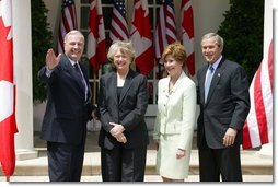 President George W. Bush and Mrs. Laura Bush with Canadian Prime Minister Paul Martin and his wife Sheila Martin after responding to questions from the press corps in the Rose Garden of the White House on April 30, 2004. White House photo by Paul Morse.