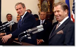 President George W. Bush listens to an interpreter during a joint press conference with Czech Republic President Vaclav Havel at Prague Castle in Prague, Czech Republic, Wednesday Nov. 20.  White House photo by Paul Morse