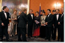 President George W. Bush and Mrs. Bush congratulate Czech Republic President Vaclav Havel during a gift presentation before a dinner for NATO leaders at Prague Castle in Prague, Czech Republic, Nov. 20. White House photo by Paul Morse